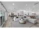 Open living room featuring a large sectional, dining area, and a modern kitchen at 2250 Bowie Cir, Henderson, NV 89014