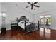 Spacious main bedroom featuring wood floors, decorative ceiling fan, and sliding door to outdoor living space at 2250 Bowie Cir, Henderson, NV 89014