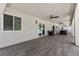 Spacious covered patio with wood-look tile flooring and multiple ceiling fans for comfortable outdoor living at 2250 Bowie Cir, Henderson, NV 89014