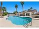 Sparkling pool with solar panel-equipped home and a covered patio in a lush backyard at 2250 Bowie Cir, Henderson, NV 89014