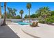 Beautiful backyard pool with lush landscaping, mature palm trees, spa, and inviting lounge chairs at 2250 Bowie Cir, Henderson, NV 89014