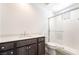 Modern bathroom featuring a glass-enclosed shower, white tiles, and a sleek vanity with dark wood cabinets at 2501 Indigo Mountain St, Henderson, NV 89044