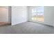 Bright, carpeted bedroom with a large window offering desert views at 2501 Indigo Mountain St, Henderson, NV 89044