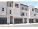 New townhome exterior featuring modern design, gray garage doors, and well-kept landscaping at 2501 Indigo Mountain St, Henderson, NV 89044