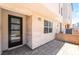 Modern home exterior with stone facade, large glass door, and paved patio, showcasing contemporary design at 2501 Indigo Mountain St, Henderson, NV 89044