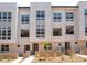 Modern townhome complex featuring covered balconies, contemporary design, and drought-tolerant landscaping at 2501 Indigo Mountain St, Henderson, NV 89044