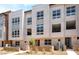 Modern townhome complex featuring covered balconies, contemporary design, and drought-tolerant landscaping at 2501 Indigo Mountain St, Henderson, NV 89044