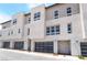 Modern townhome exterior with clean lines, gray garages, and well maintained landscaping at 2501 Indigo Mountain St, Henderson, NV 89044