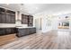 Bright, open kitchen with hardwood floors, an island, modern appliances, and dark cabinets, offering a modern aesthetic at 2501 Indigo Mountain St, Henderson, NV 89044