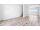 Spacious open-concept living room with sleek hardwood floors, modern staircase, and an abundance of natural light at 2501 Indigo Mountain St, Henderson, NV 89044