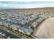 Wide aerial shot showcases a neatly planned community with uniform homes and tidy landscaping against a mountain backdrop at 2699 Chance Canyon St, Henderson, NV 89044