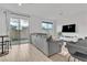 Bright living space with a comfortable gray sofa, natural light and sliding glass doors leading to the patio at 2699 Chance Canyon St, Henderson, NV 89044