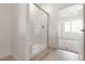 This bathroom offers a modern shower with glass door, neutral paint, and white cabinets at 2727 Avril Point St, Las Vegas, NV 89156