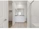 Bright bathroom featuring walk-in closet, white cabinets, and shower with glass door at 2727 Avril Point St, Las Vegas, NV 89156