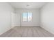 Sun-filled carpeted bedroom with large window, neutral paint, and ample space create a peaceful atmosphere at 2727 Avril Point St, Las Vegas, NV 89156
