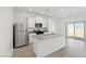 Bright kitchen featuring stainless steel appliances, a kitchen island, and sleek white cabinetry at 2727 Avril Point St, Las Vegas, NV 89156