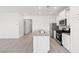 Bright kitchen featuring stainless steel appliances, a kitchen island, and sleek white cabinetry at 2727 Avril Point St, Las Vegas, NV 89156