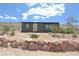 Charming home with a desert landscape, surrounded by rocks and native plants with mountain views at 275 Vegas Dr, Goodsprings, NV 89019