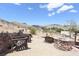 Inviting fire pit area with stone seating, ideal for outdoor gatherings and enjoying the natural scenery at 275 Vegas Dr, Goodsprings, NV 89019