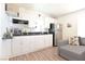 Charming kitchen with white cabinets, black countertops, and stainless steel refrigerator at 275 Vegas Dr, Goodsprings, NV 89019