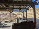 Relaxing outdoor space with covered patio, ceiling fan, and comfortable seating, perfect for enjoying the natural surroundings at 275 Vegas Dr, Goodsprings, NV 89019