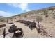 Inviting outdoor patio featuring comfortable seating and a cozy fire pit for relaxation and enjoying the desert landscape at 275 Vegas Dr, Goodsprings, NV 89019