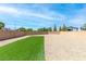 This backyard offers a gravel area with a section of artificial turf, all enclosed by a brick wall at 298 Grant Ridge Dr, Henderson, NV 89012