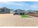 This is a backyard with gravel, artificial turf, a brick wall, and the exterior of the home at 298 Grant Ridge Dr, Henderson, NV 89012