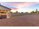Expansive backyard with gravel landscaping, a covered patio, and an artificial turf area at 298 Grant Ridge Dr, Henderson, NV 89012