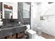 Modern bathroom with stone sink, sleek fixtures, marble tiling and glass-enclosed shower at 298 Grant Ridge Dr, Henderson, NV 89012