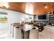 Elegant dining area with marble floors, a wooden ceiling, and a large dining table with seating for ten at 298 Grant Ridge Dr, Henderson, NV 89012