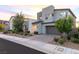Modern two-story home with desert landscaping and a two-car garage on a sunny day at 298 Grant Ridge Dr, Henderson, NV 89012