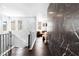 Hallway with marble accent wall, hardwood floors, and a staircase with white railing at 298 Grant Ridge Dr, Henderson, NV 89012
