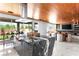 Open-concept kitchen with marble countertops, modern island, wood ceiling, and backyard views at 298 Grant Ridge Dr, Henderson, NV 89012
