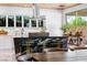 Modern kitchen featuring a black marble island, white cabinets, and stainless steel appliances at 298 Grant Ridge Dr, Henderson, NV 89012