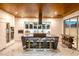 Modern kitchen featuring marble floors and countertops, an island with seating, and stainless appliances at 298 Grant Ridge Dr, Henderson, NV 89012
