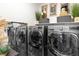 Spacious laundry room featuring modern washer and dryer units, complemented by stylish decor and ample storage space at 298 Grant Ridge Dr, Henderson, NV 89012