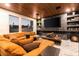 Modern living room with a fireplace, built-in shelves, an orange couch, and high ceilings at 298 Grant Ridge Dr, Henderson, NV 89012