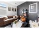 Cozy living room featuring a leather sofa, decorative pillows, and stylish decor at 298 Grant Ridge Dr, Henderson, NV 89012