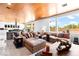 Open-concept living room featuring a modern design, wood ceilings, and large windows with natural light at 298 Grant Ridge Dr, Henderson, NV 89012