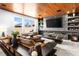 Stylish living room with a wooden ceiling, marble fireplace, and a comfortable sofa at 298 Grant Ridge Dr, Henderson, NV 89012