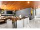 Elegant living area featuring a wooden ceiling, marble floors, and a dining table with seating for eight at 298 Grant Ridge Dr, Henderson, NV 89012