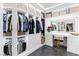 Well-organized walk-in closet with custom shelving and mirrored vanity at 298 Grant Ridge Dr, Henderson, NV 89012