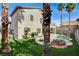 Backyard with pool, covered patio, and grassy area, perfect for entertaining at 313 Vista Glen St, Las Vegas, NV 89145