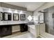 Modern bathroom with double vanity, soaking tub, and walk-in shower with gray tile at 313 Vista Glen St, Las Vegas, NV 89145