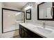 Modern bathroom features a double vanity with quartz counters and shower over tub at 313 Vista Glen St, Las Vegas, NV 89145