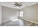 Neutral bedroom features wood-look floors, natural light and a ceiling fan at 313 Vista Glen St, Las Vegas, NV 89145