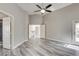 Large bedroom featuring wood floors, doors to bathroom and hallway, and a ceiling fan at 313 Vista Glen St, Las Vegas, NV 89145