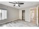 Bright bedroom with gray wood floors, closet and view to ensuite bath at 313 Vista Glen St, Las Vegas, NV 89145