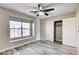 Bedroom offers gray wood-look floors, ceiling fan and closet space at 313 Vista Glen St, Las Vegas, NV 89145